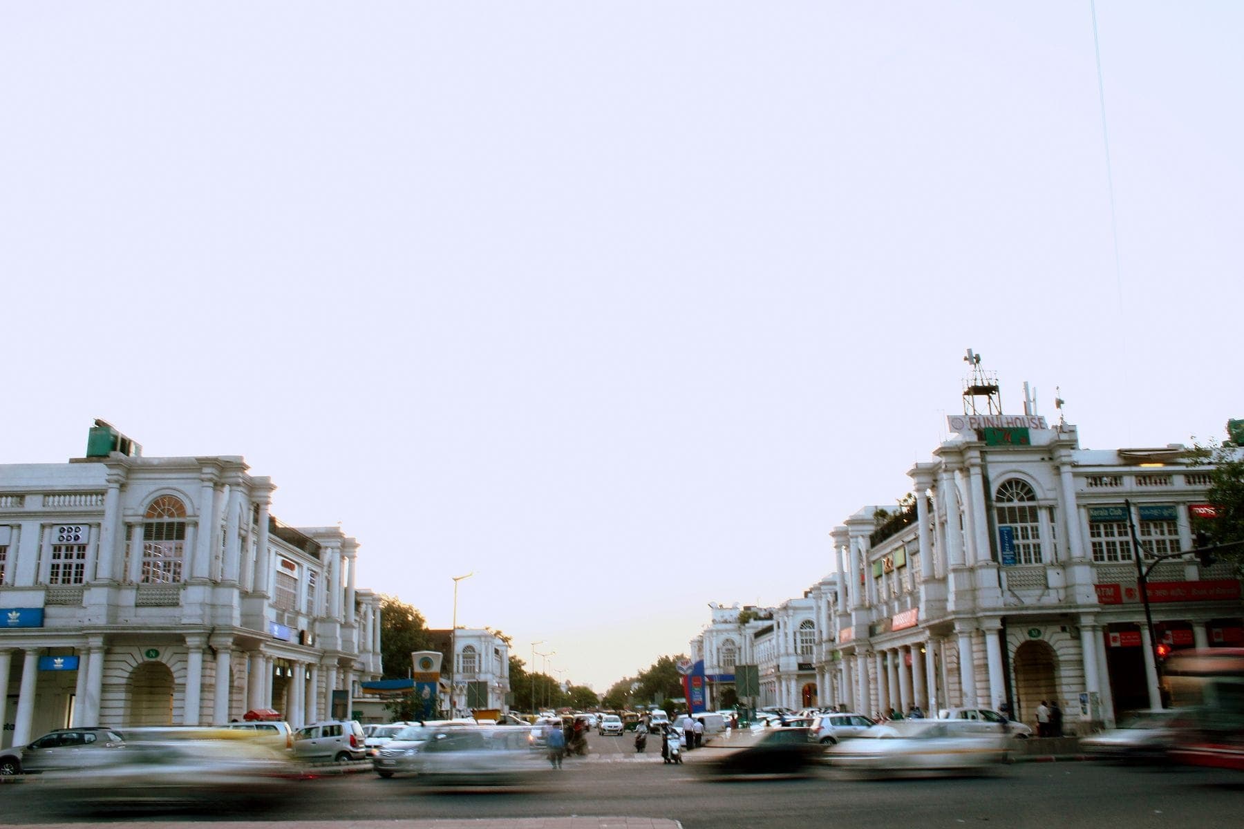 Traffic crossing Connaught Place in Delhi at dusk