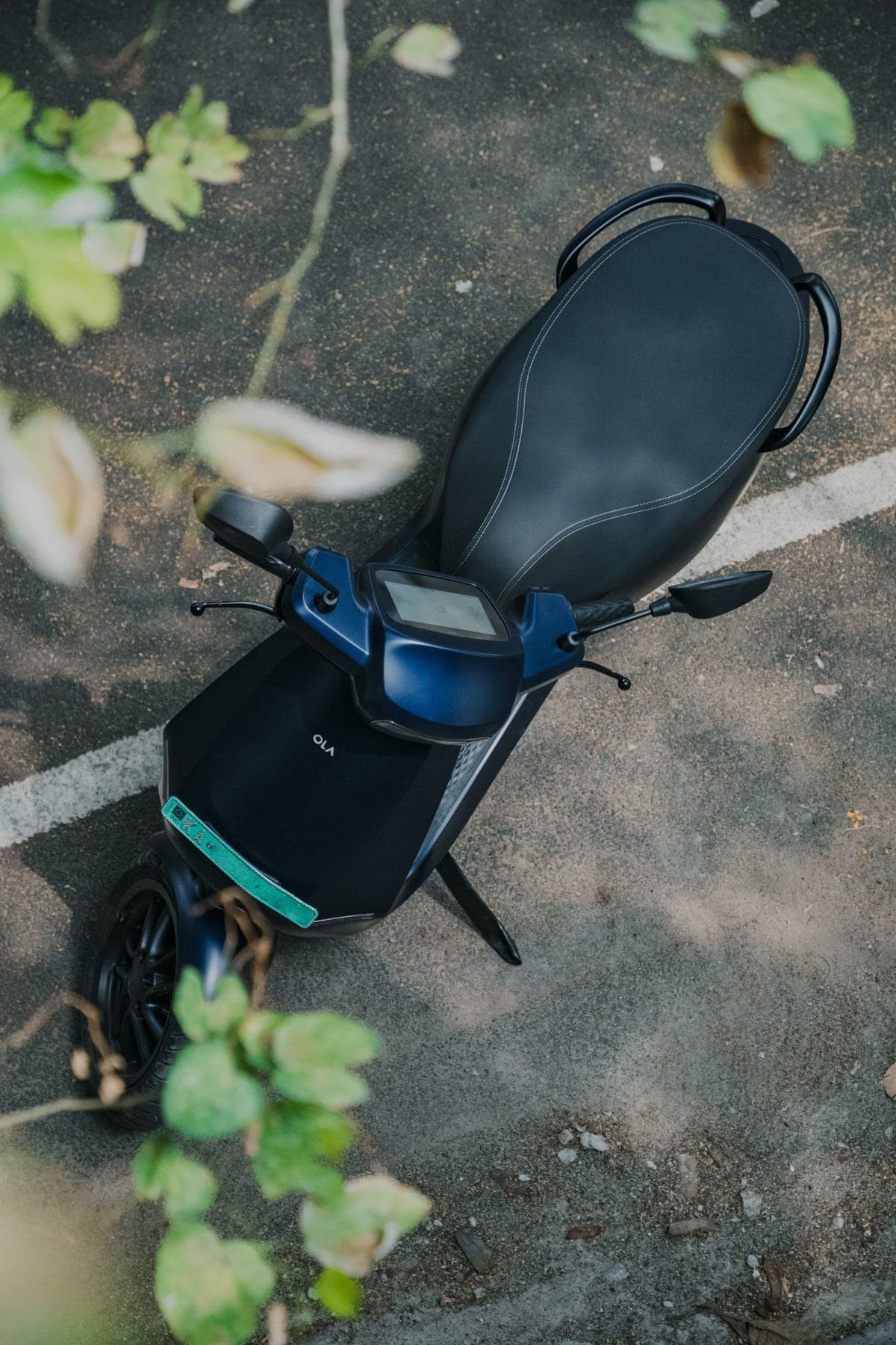 An electric scooter seen from above, parked on asphalt